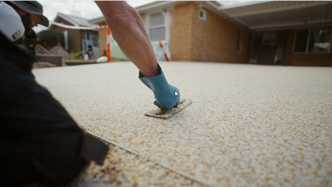 resin bound installer trowls paving